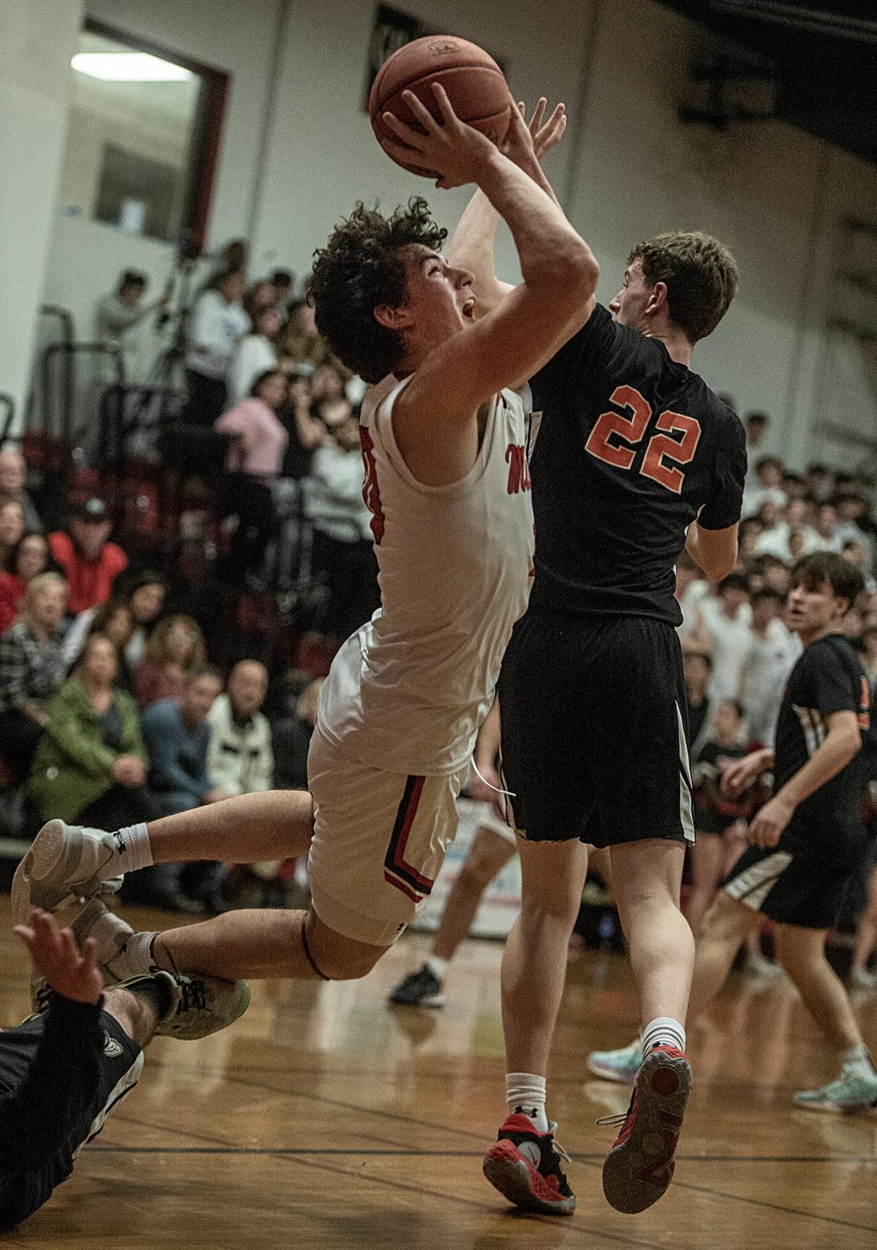 Milford High School junior captain Andrew Rivera heads to the basket against Middleborough's Matt Youngquist in a Div. 2 Sweet 16 playoff game on March 6, 2024.