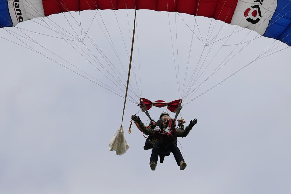 Texas Gov. Greg Abbott skydives in tandem Monday, Nov. 27, 2023, in Fentress, Texas. Abbott was invited to jump by 106-year-old World War II veteran Al Blaschke. (AP Photo/Eric Gay)