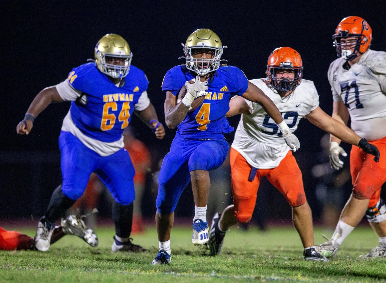 Cardinal Newman running back takes off against Benjamin in their regional semifinal playoff football game in West Palm Beach on November 17, 2023.