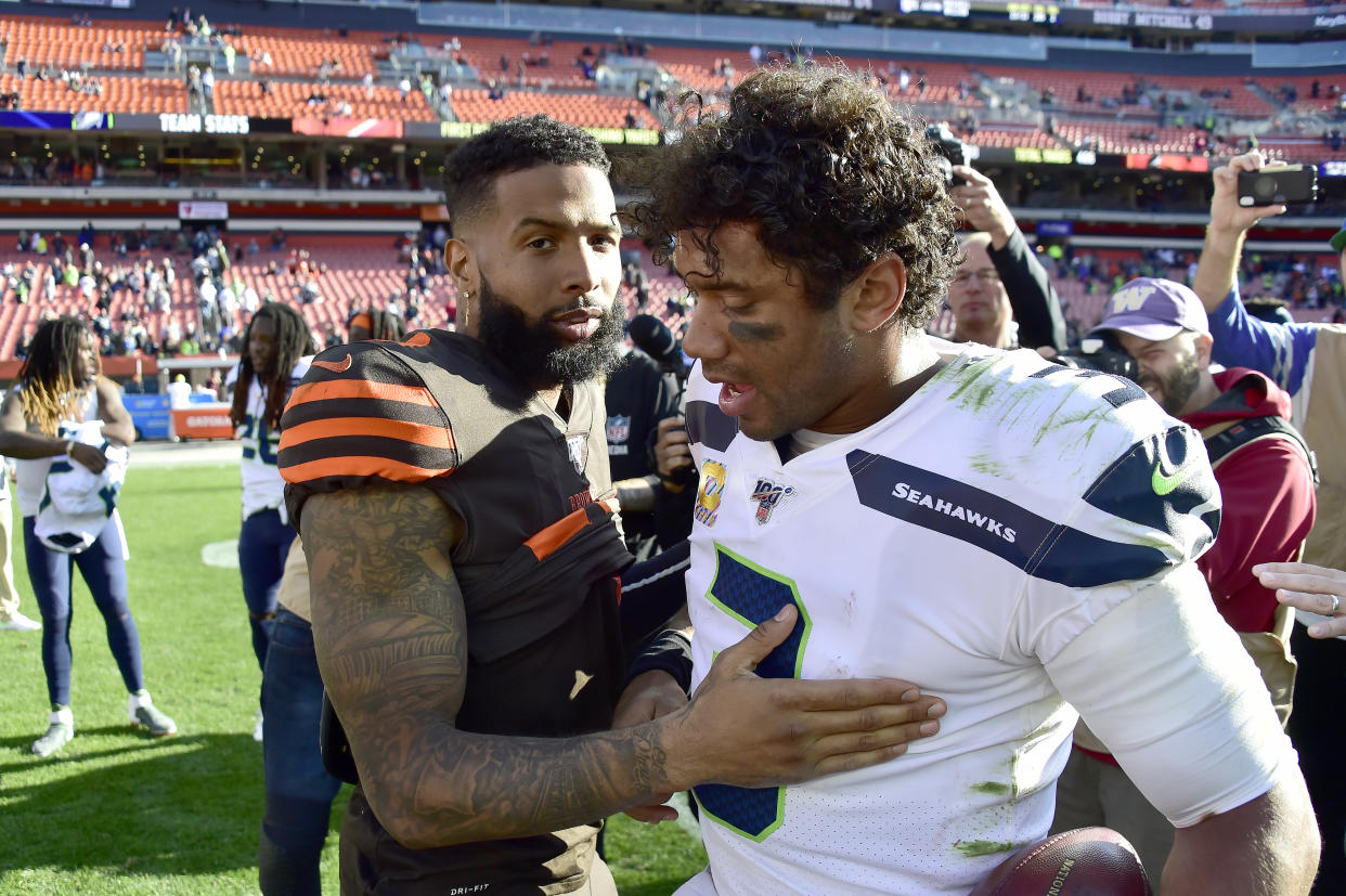 Odell Beckham #13 of the Cleveland Browns and Russell Wilson #3 of the Seattle Seahawks congratulate each other after the game at FirstEnergy Stadium on October 13, 2019 in Cleveland, Ohio. The Seahawks defeated the Browns 32-28.  (Photo by Jason Miller/Getty Images)