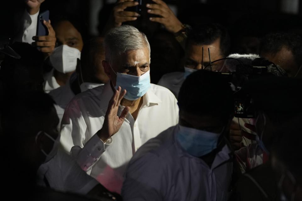 Sri Lanka's new prime minister Ranil Wickremesinghe waves as he leaves a temple after attending religious observances in Colombo, Sri Lanka, Thursday, May 12, 2022. Five-time former Sri Lankan Prime Minister Ranil Wickremesinghe was reappointed Thursday in an effort to bring stability to the island nation, engulfed in a political and economic crisis. (AP Photo/Eranga Jayawardena)