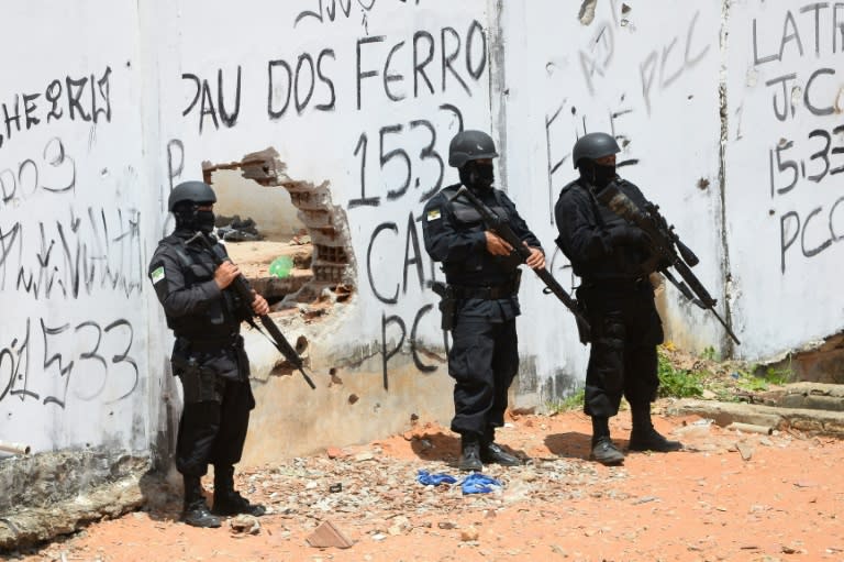 Riot police enter the Alcacuz Penitentiary Center to regain control after a gang confrontation at the prison