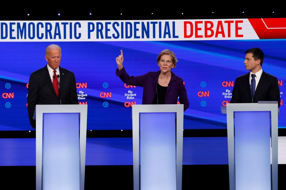 Democratic presidential candidate former Vice President Joe Biden, left, Sen. Elizabeth Warren, D-Mass., and South Bend Mayor Pete Buttigieg, right, participate in a Democratic presidential primary debate hosted by CNN/New York Times at Otterbein University, Tuesday, Oct. 15, 2019, in Westerville, Ohio. (AP Photo/John Minchillo)