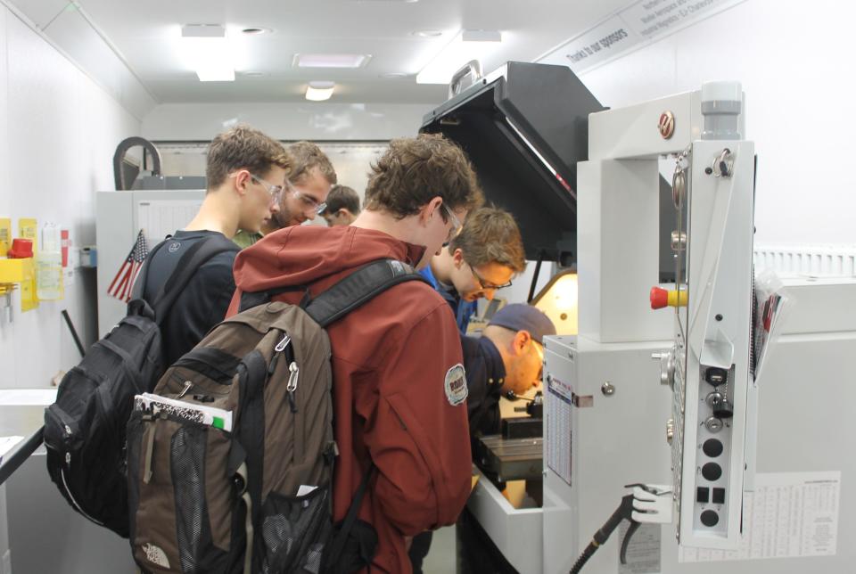 A group of students check out the North Central Michigan College Mobile Digital FAB LAB.