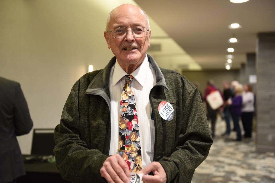 Airforce veteran and election judge Jim Hagenbrock holds a photo with his roll of 'I Pick Nikki' stickers at Nikki Haley's rally in Bloomington, Minn. on Feb. 26, 2024. ahead of the Super Tuesday presidential nominating contest.