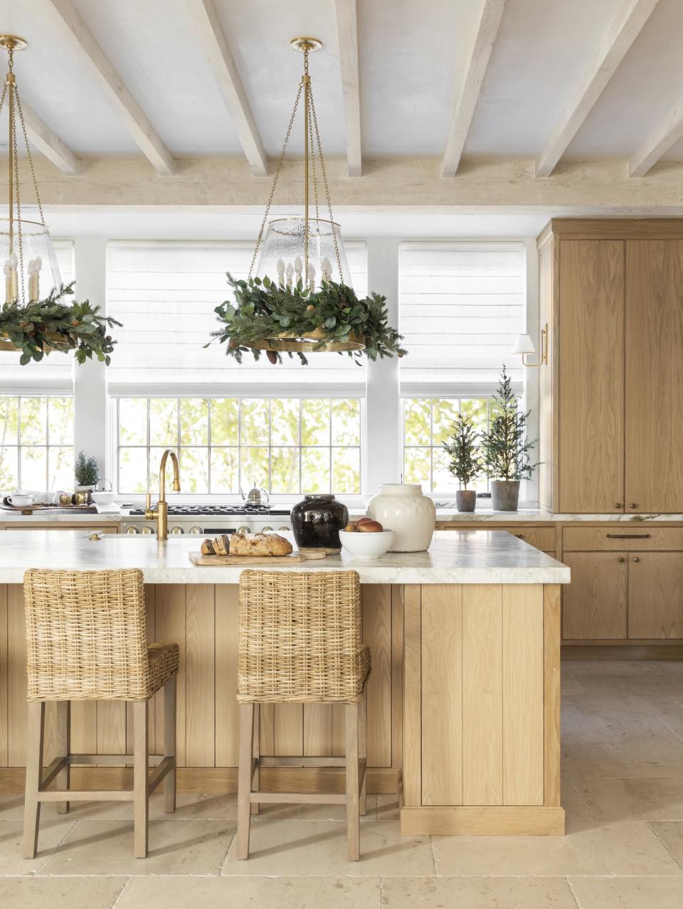 Christmas kitchen with garlands on pendant lights by Marie Flanigan