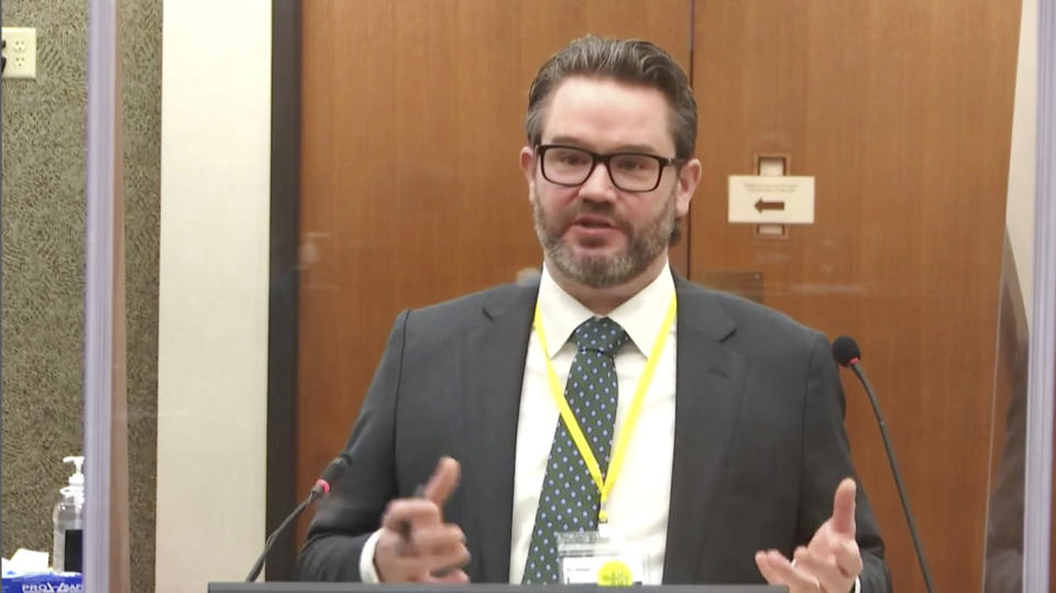 In this image taken from video, defense attorney Eric Nelson questions witness Los Angeles police department Sgt. Jody Stiger, as Hennepin County Judge Peter Cahill presides Wednesday, April 7, 2021, in the trial of former Minneapolis police Officer Derek Chauvin at the Hennepin County Courthouse in Minneapolis. Chauvin is charged in the May 25, 2020 death of George Floyd. (Court TV via AP, Pool)