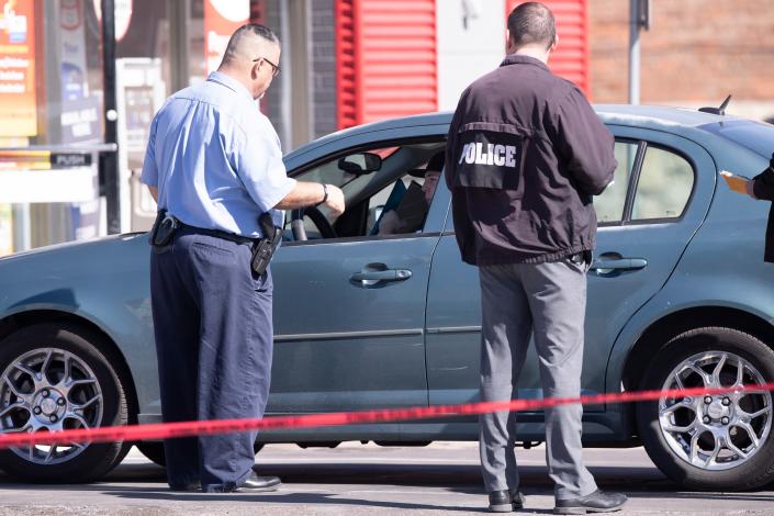 Police detectives investigate a shooting at a convenience store at 5201 Fairbanks Drive in Northeast El Paso on Monday.