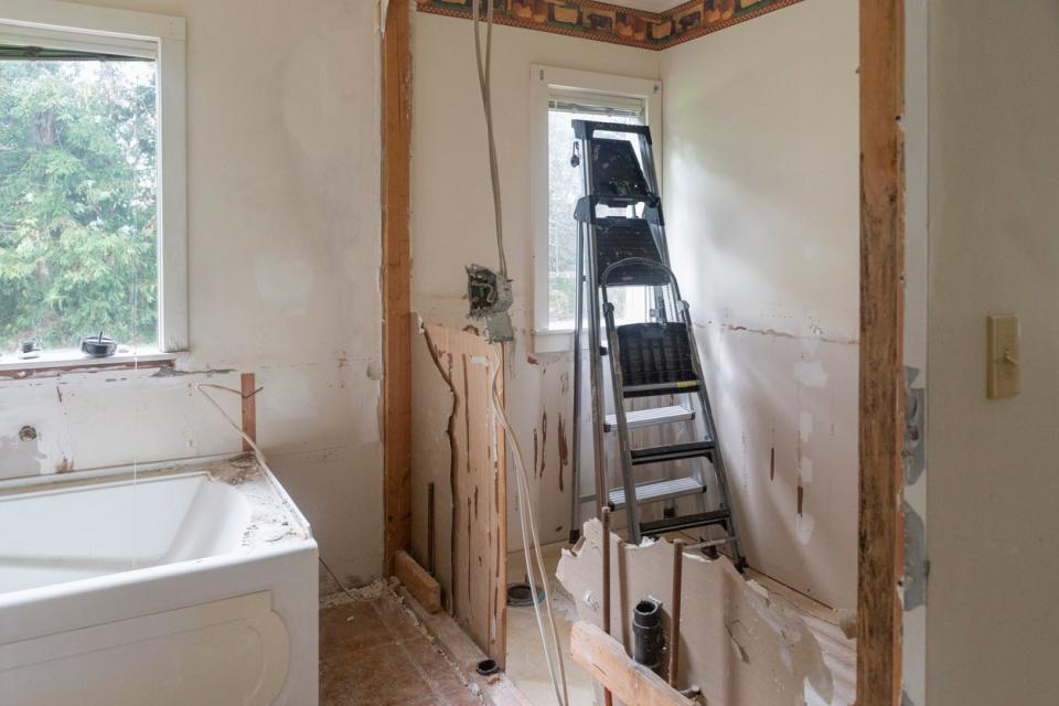 A view of the interior of a bathroom undergoing a remodel. 