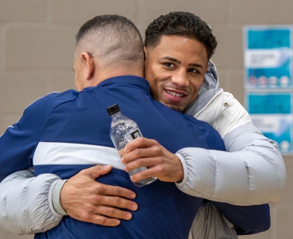 Worcester boxer Jamaine Ortiz gets a hug from former world champion boxer Jose Rivera during a recent send-off event for Ortiz at the Boys & Girls Club of Worcester.