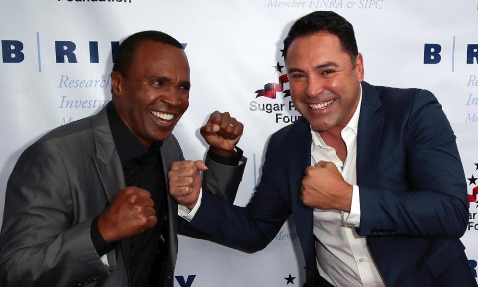 Oscar De La Hoya (right), pictured with Sugar Ray Leonard at a charity event