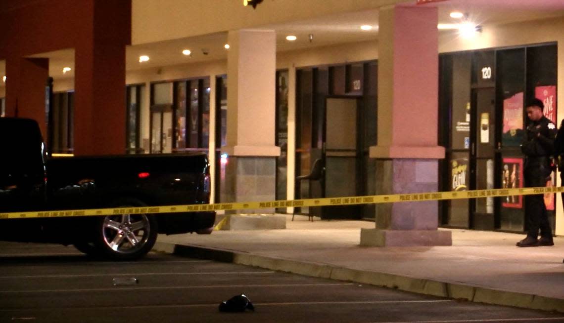 Police tape up the parking lot at Herndon Place at Milburn Avenue after one person was shot and killed and another critically injured at a hookah lounge in Fresno, California on Sunday, Feb. 19, 2023. The second person later died at a local hospital, police said.