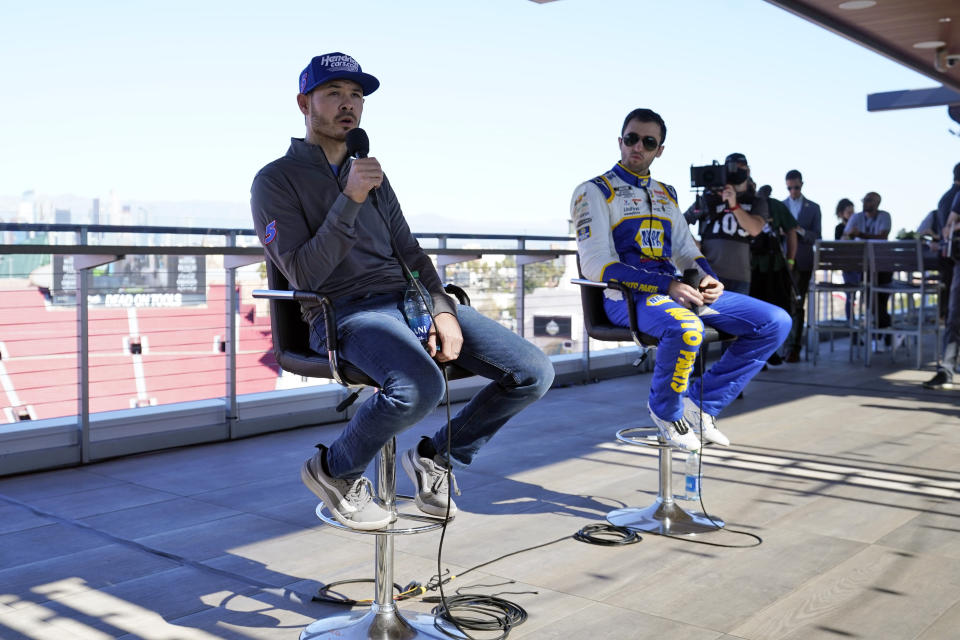 Kyle Larson, left, and Chase Elliott answer questions after a practice session at the Los Angeles Memorial Coliseum, Saturday, Feb. 5, 2022, in Los Angeles, ahead of a NASCAR exhibition auto race. (AP Photo/Marcio Jose Sanchez)