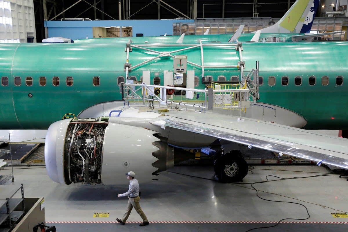 A worker walks past a Boeing 737-MAX under construction (REUTERS)