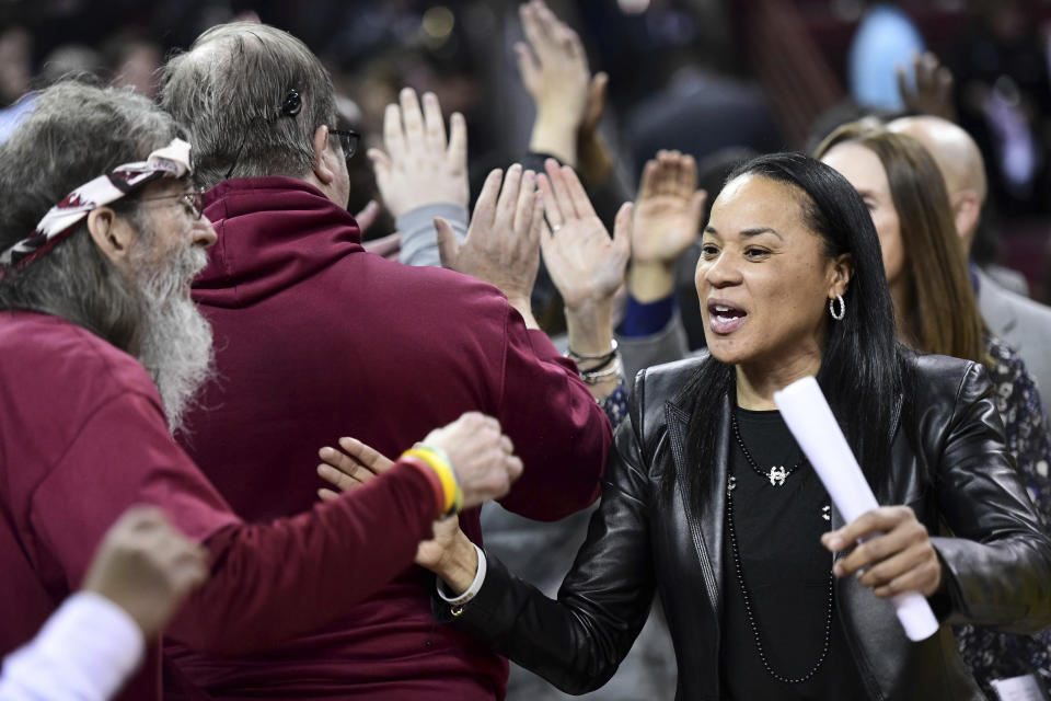 South Carolina coach Dawn Staley celebrates with fans after an NCAA college basketball game against Vanderbilt Monday, Feb. 17, 2020, in Columbia, S.C. South Carolina defeated Vanderbilt 95-44. (AP Photo/Sean Rayford)