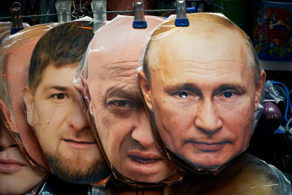 Masks showing the faces of Putin, Prigozhin and Chechnya's regional leader Ramzan Kadyrov on display at a souvenir shop in St Petersburg (AP)
