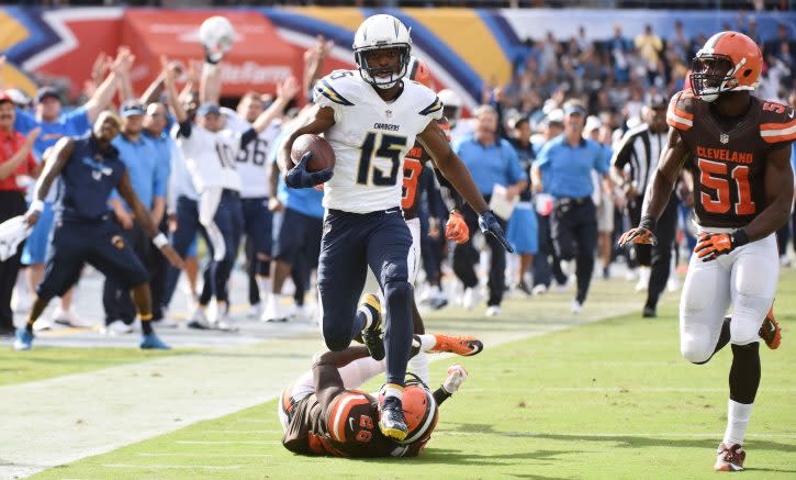 Oct 4, 2015; San Diego, CA, USA; San Diego Chargers wide receiver Dontrelle Inman (15) leaps over Cleveland Browns cornerback Pierre Desir (26) on his way to a 68-yard play in the fourth quarter at Qualcomm Stadium. The Chargers went on to a 30-27 win. Mandatory Credit: Robert Hanashiro-USA TODAY Sports