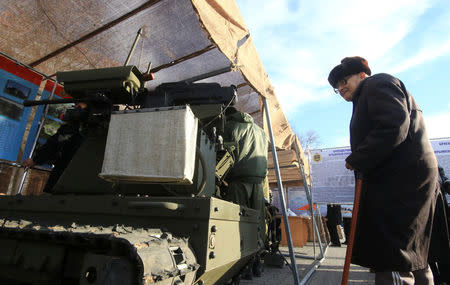 A man attends a military equipment exhibition during celebrations of the Defender of the Fatherland Day in the Black Sea port of Sevastopol, Crimea, February 23, 2016. Picture taken February 23, 2016. REUTERS/Pavel Rebrov