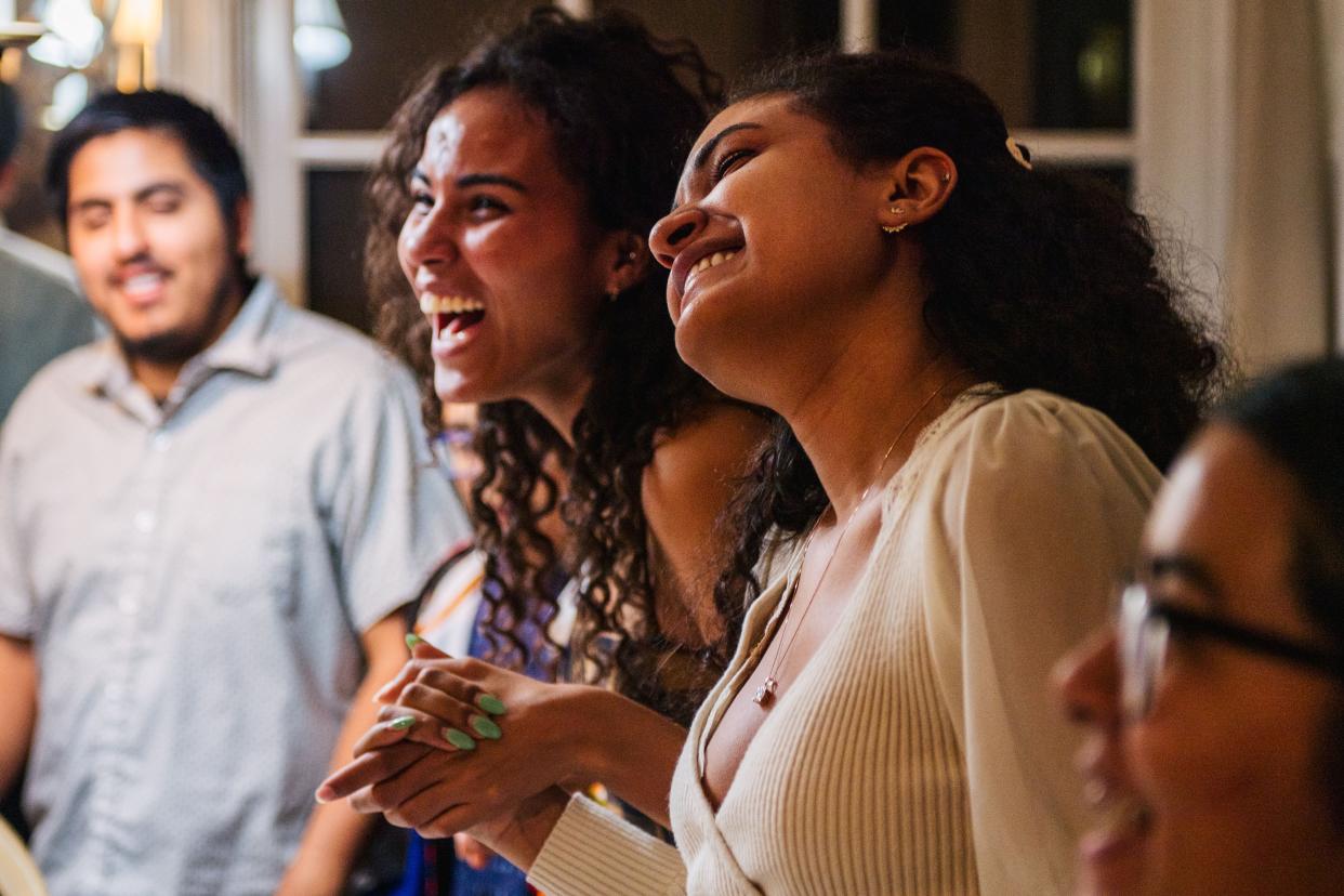 Lucila Broughton (R) and her sister Jada Broughton (L) prepare to pray with their family during a gathering on Nov. 26, 2020 in Los Angeles, California. Families have adjusted plans under CDC guidelines.