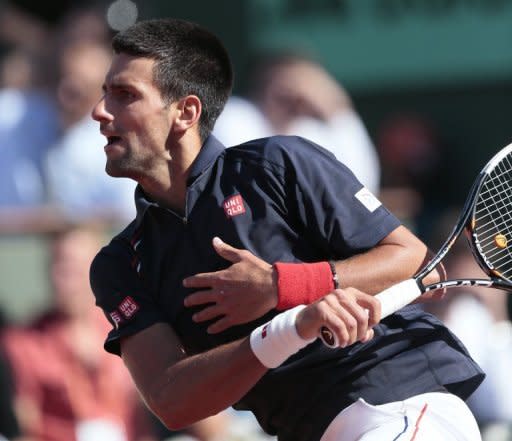 Novak Djokovic hits a return to Roger Federer during their semi-final match of the French Open tennis tournament at Roland Garros, on June 8, in Paris. Djokovic and Rafael Nadal square off in a record fourth successive Grand Slam final on Sunday with the French Open title and a place in tennis folklore at stake