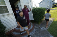 Angelo Bernard, who lives near the Denka Performance Elastomer Plant, walks out of his home with his grandchildren, who are visiting him for the weekend, in Reserve, La., Friday, Sept. 23, 2022. From left are Anthony Bernard,10, Korinne Bernard, 11, and Karmen Bernard, 9, who used to attend Fifth Ward Elementary until Hurricane Ida forced them to move. "I feel for the kids that have to go to school that close to the plant," Angelo Bernard said. (AP Photo/Gerald Herbert)