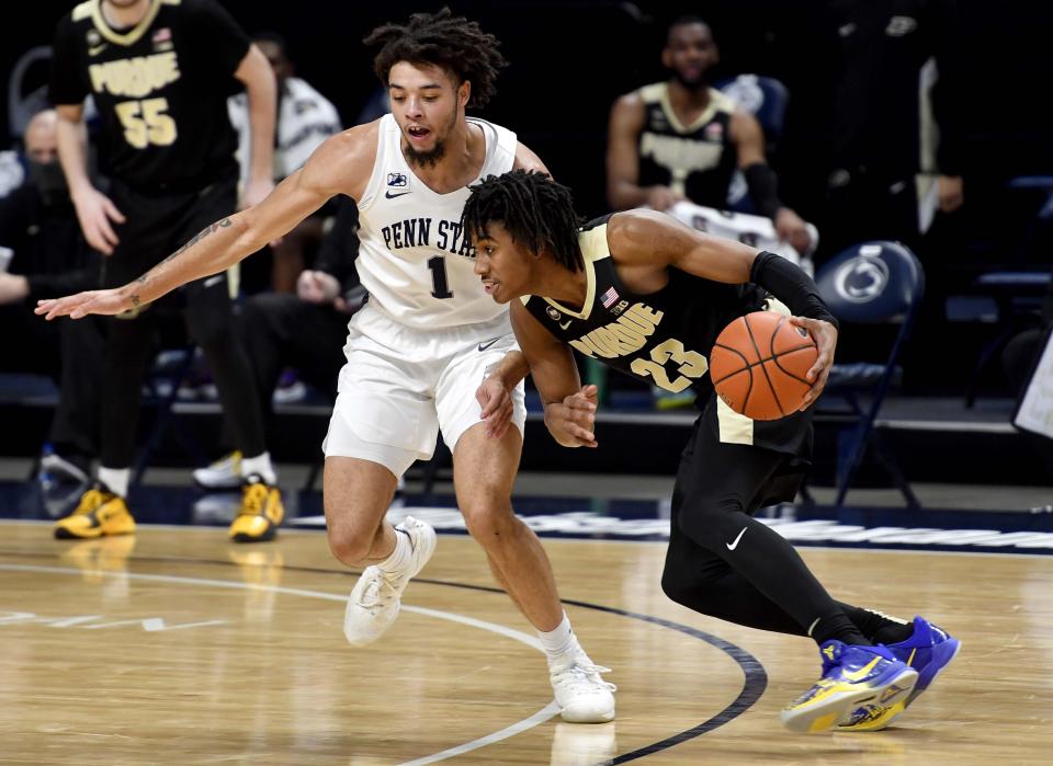 Purdue's Jaden Ivey dribbles around Penn State's Seth Lundy during an NCAA college basketball game Friday, Feb. 26, 2021, in State College, Pa. (Abby Drey/Centre Daily Times via AP)