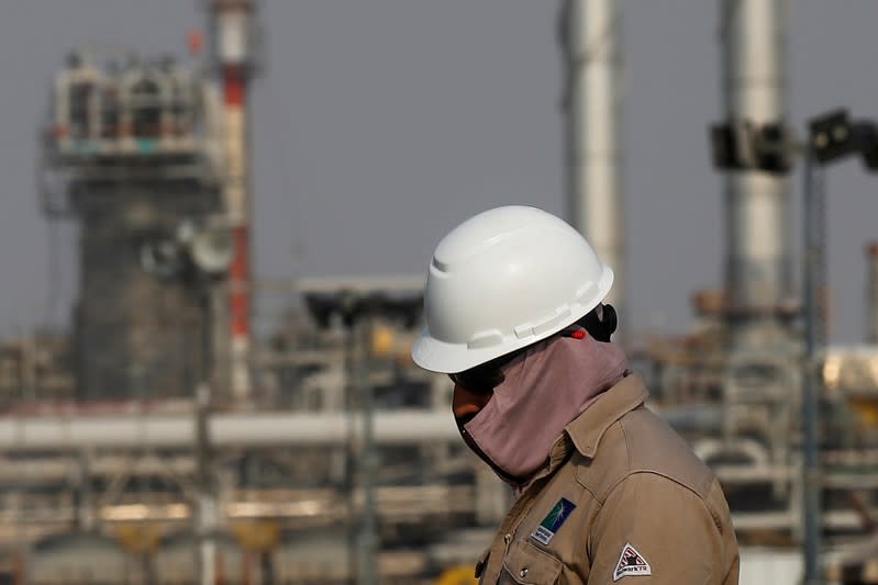 FILE PHOTO: FILE PHOTO: FILE PHOTO: An employee looks on at Saudi Aramco oil facility in Abqaiq