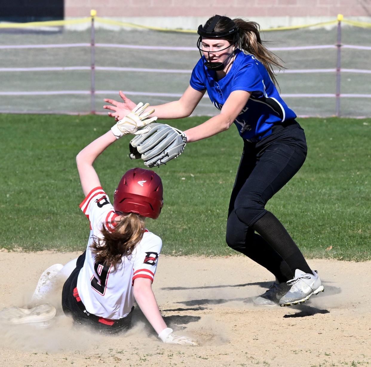 Sara Ormston of Barnstable slides safely into second ahead of the tag by Mashpee shortstop Hailey Scholl.