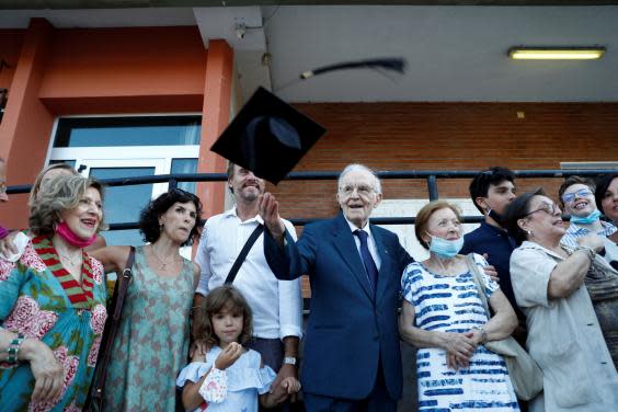 Paterno celebrates with his family after graduating (Reuters/Guglielmo Mangiapane)