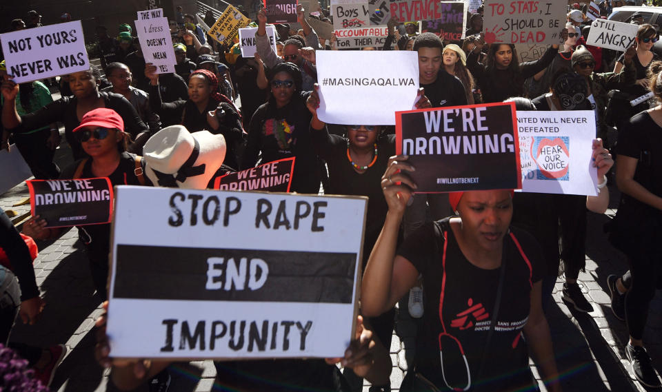 Demonstrators hold up banners in Sandton, Johannesburg, Friday Sept. 13, 2019, as they protest against gender-based violence. The protesters are calling on President Cyril Ramaphosa to declare a state of emergency a day after the country's latest crime statistics were released. (AP Photo)