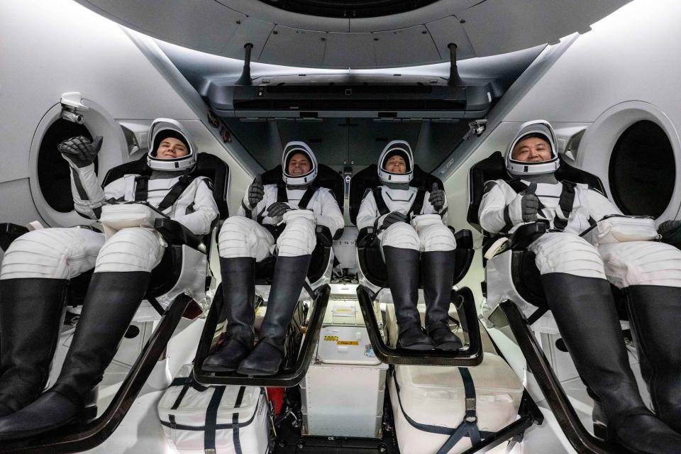 All four members of NASA's SpaceX Crew-5 mission, Roscosmos cosmonaut Anna Kikina, left, NASA astronauts Josh Cassada and Nicole Mann, and Japan Aerospace Exploration Agency (JAXA) astronaut Koichi Wakata, right, give a thumbs up upon splashdown of the Dragon Endurance capsule in the Gulf of Mexico on Saturday, March 11, concluding a nearly six-month mission aboard the ISS.