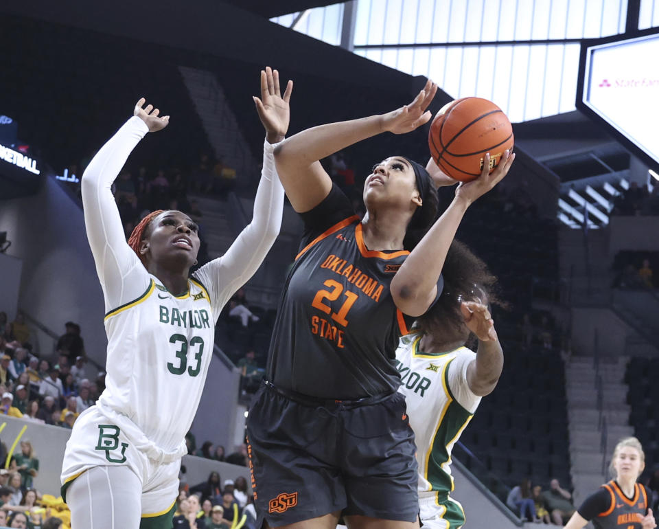 Oklahoma State center Hannah Gusters shoots past Baylor guard Aijha Blackwell in the first half of an NCAA college basketball game, Sunday, March 3, 2024, in Waco, Texas. (Rod Aydelotte/Waco Tribune-Herald via AP)
