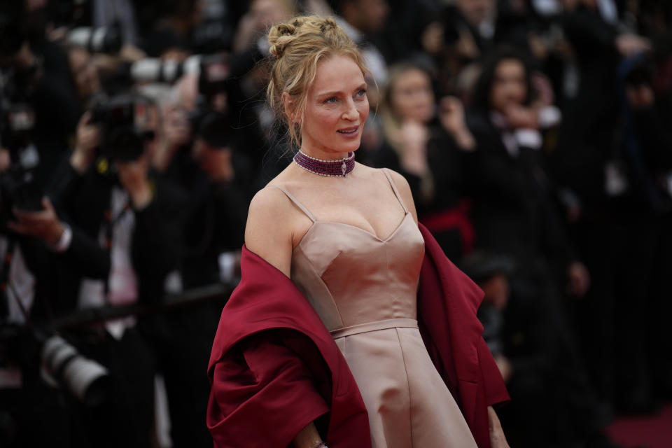 Uma Thurman poses for photographers upon arrival at the opening ceremony and the premiere of the film 'Jeanne du Barry' at the 76th international film festival, Cannes, southern France, Tuesday, May 16, 2023. (AP Photo/Daniel Cole)