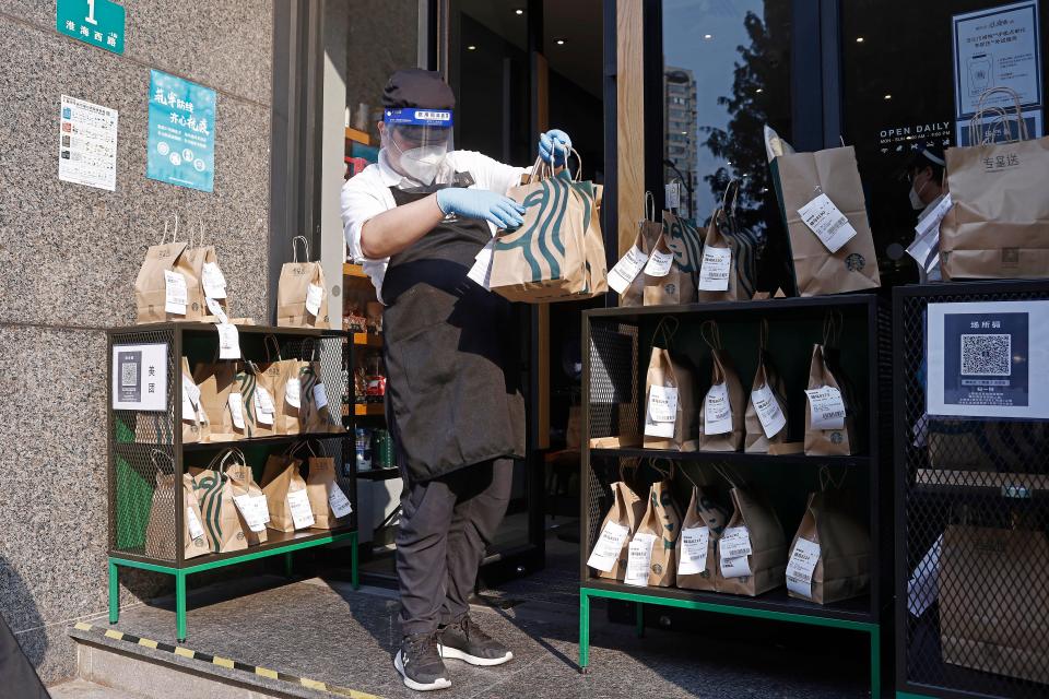 A Starbucks employee prepares takeaway orders. Starbucks stores were either temporarily closed or offered delivery or MOP payments only, Starbucks said recently.