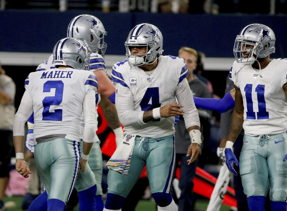 Dallas Cowboys' Brett Maher (2), Dak Prescott (4) and Ced Wilson (11) celebrate a 63 yard field goal kicked by Maher in the first half of an NFL football game against the Philadelphia Eagles in Arlington, Texas, Sunday, Oct. 20, 2019. (AP Photo/Michael Ainsworth)