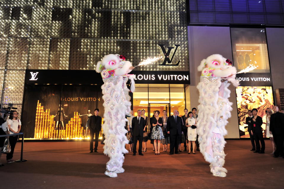 Entertainers perform lion dance during the opening ceremony of the Louis Vuitton flagship store at the Chengdu Yanlord Landmark mall in Chengdu city. - Credit: Tan tan - Imaginechina/AP