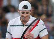 John Isner of the U.S. reacts during his third round singles match against Switzerland's Stan Wawrinka at the Australian Open tennis championship in Melbourne, Australia, Saturday, Jan. 25, 2020. (AP Photo/Andy Wong)