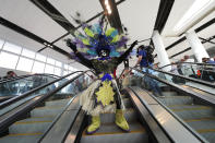 CORRECTS CITY TO KENNER, NOT BATON ROUGE- Members of the Zulu Social Aid & Pleasure Club Tramps lead a second line parade down escalators during festivities for the opening of the newly built main terminal of the Louis Armstrong New Orleans International Airport in Kenner, La., Tuesday, Nov. 5, 2019. (AP Photo/Gerald Herbert)