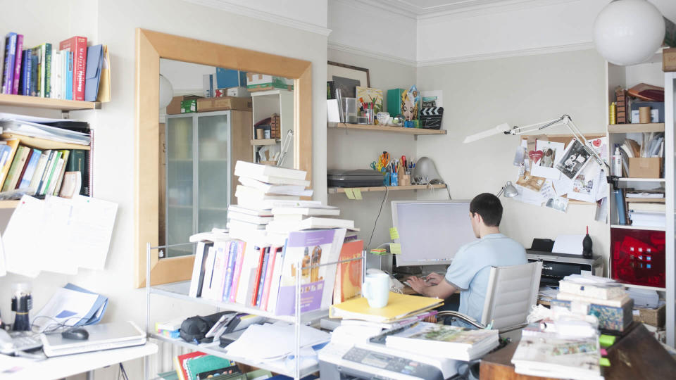 Rear view of businessman using computer in creative office space.