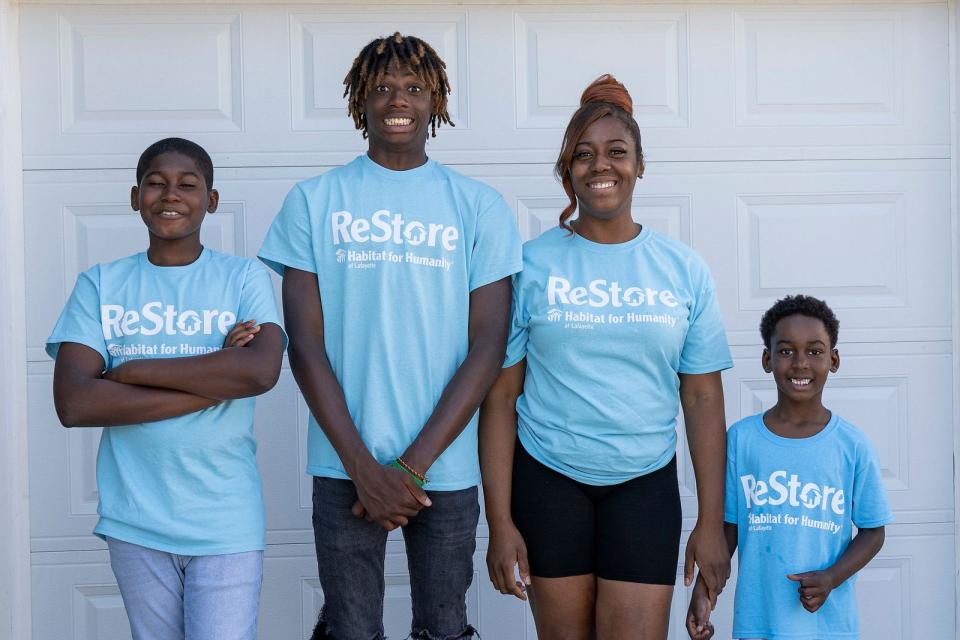 The Morris Family, (left to right) Omari, Omar “OJ”, Val and Omyr pose outside their new house at the Habitat for Humanity Restore Build House Blessing, June 28, 2022, in Lafayette, Ind.