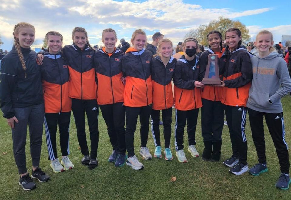 Central Kitsap's girls cross country team poses with the Class 3A state runner-up trophy Saturday at Sun Willows Golf Course in Pasco in November 2021.