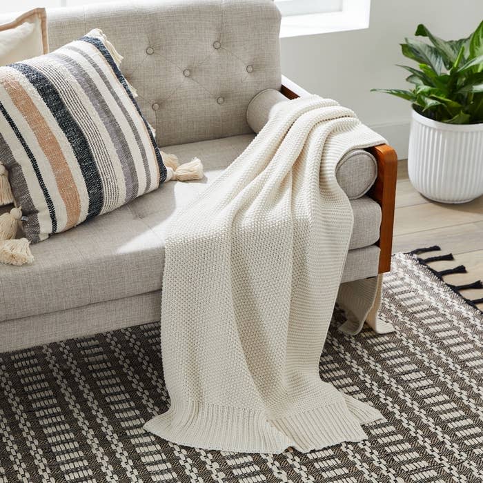 white knit throw on a beige couch