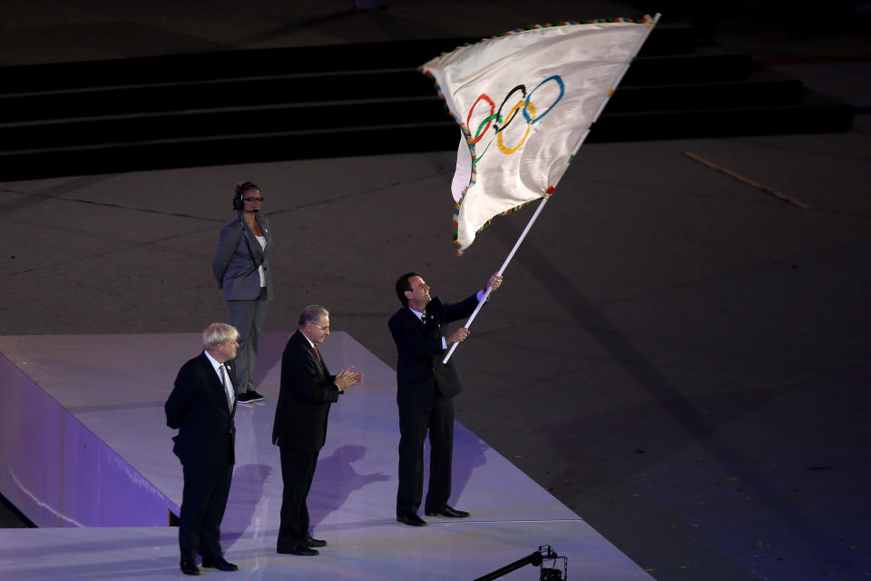 LONDON, ENGLAND - AUGUST 12: The Olympic Flag is handed from Mayor of London, Boris Johnson to IOC President Jacques Rogge, who passes it to Mayor of Rio de Janeiro, Eduardo Paes during the Closing Ceremony on Day 16 of the London 2012 Olympic Games at Olympic Stadium on August 12, 2012 in London, England. (Photo by Clive Brunskill/Getty Images)