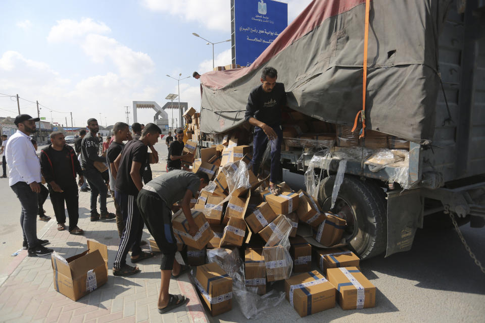 Palestinians loot a truck with humanitarian aid near the Rafah border crossing in the Gaza Strip on Thursday, Nov. 2, 2023. (AP Photo/Hatem Ali)