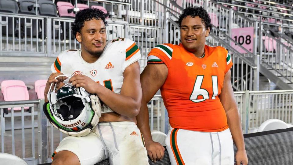 Miami Hurricanes linebacker Francisco Mauigoa (51) and his brother offensive lineman Francis Mauigoa (61) talk after they finished playing their spring game at DRV PNK Stadium on Friday, April 14, 2023, in Fort Lauderdale, Fla.
