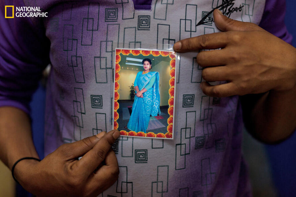 Guest workers in Dubai hold pictures of family members back home.