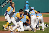 Members of the Honolulu Little League team celebrate their win against Curacao in the Little League World Series Championship baseball game in South Williamsport, Pa., Sunday, Aug. 28, 2022. Honolulu won 13-3. (AP Photo/Tom E. Puskar)