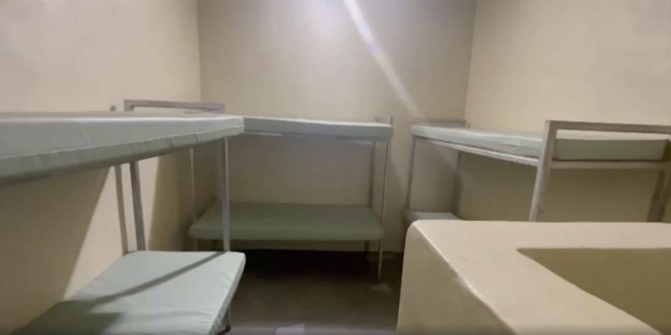 A Fox Hill cell with three bunk beds and a toilet.