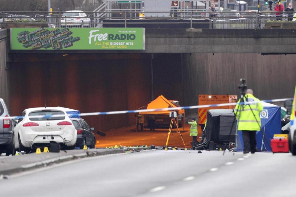 Investigators at the scene of the fatal crash (PA)