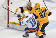 New York Islanders' Anthony Beauvillier (18) gets a shot past Pittsburgh Penguins goaltender Tristan Jarry (35) with Penguins' Sidney Crosby (87) defending during the first period in Game 5 of an NHL hockey Stanley Cup first-round playoff series in Pittsburgh, Monday, May 24, 2021. (AP Photo/Gene J. Puskar)